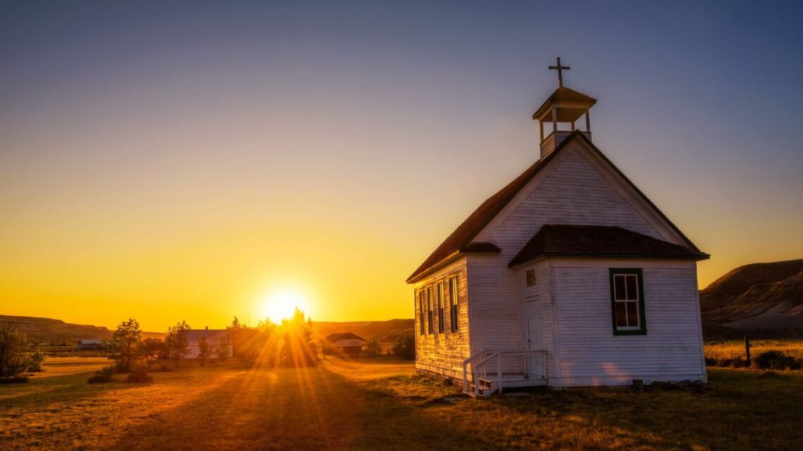 A sunset over an old church building