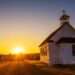 A sunset over an old church building