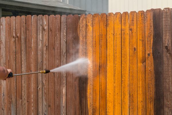 Pressure washing a wooden fence